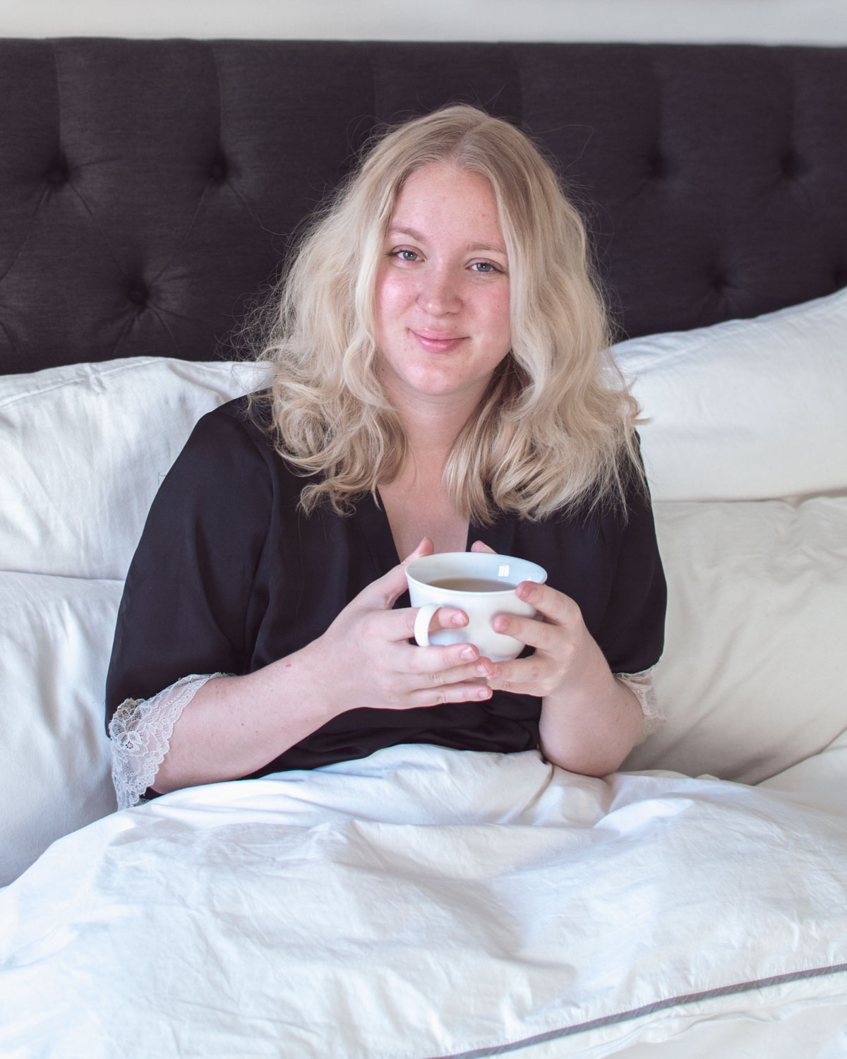 Blonde Woman drinking tea in bed